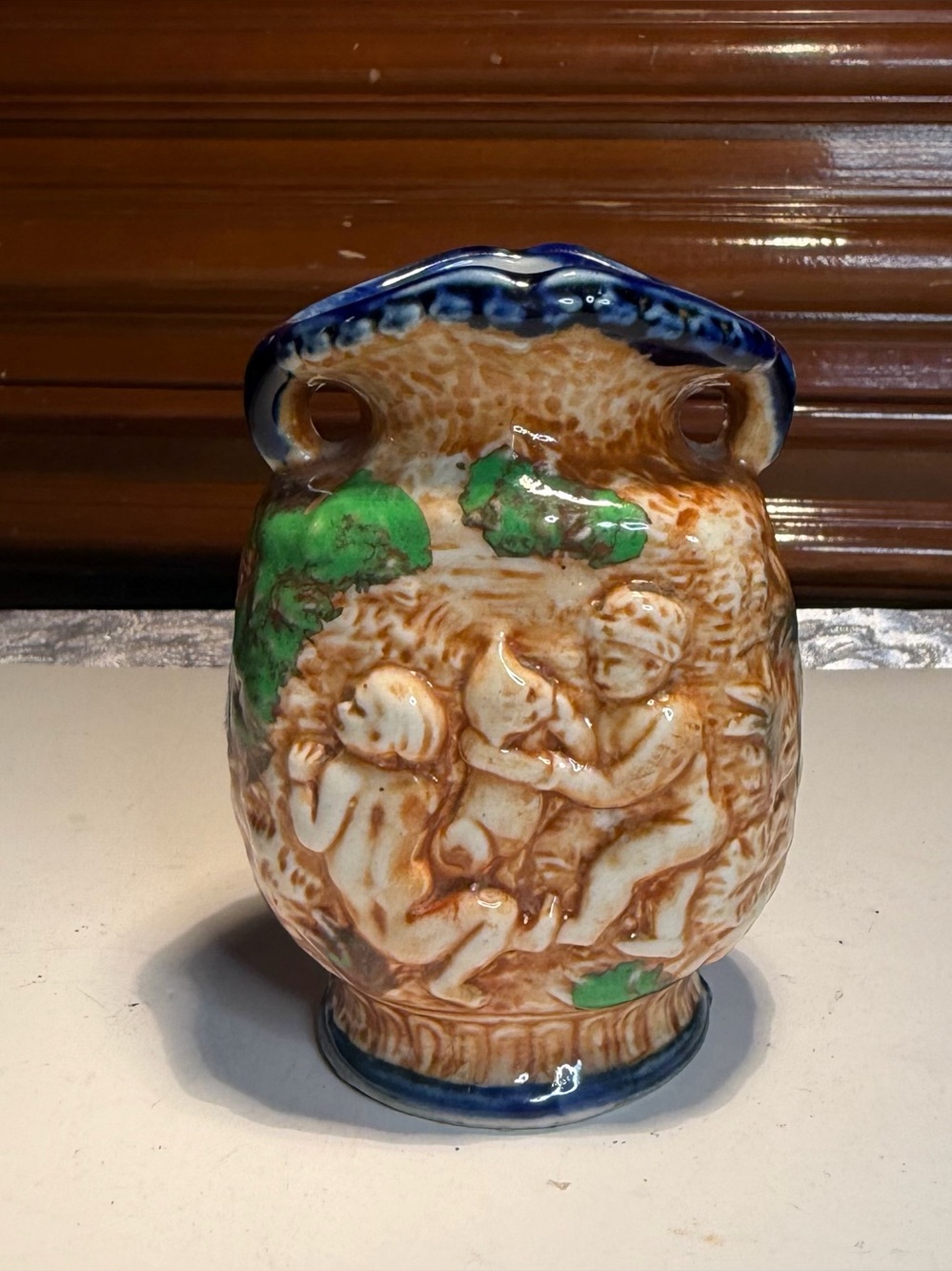 Vintage Japanese Majolica-style Vase Featuring Raised Putti Figures Blue Rim